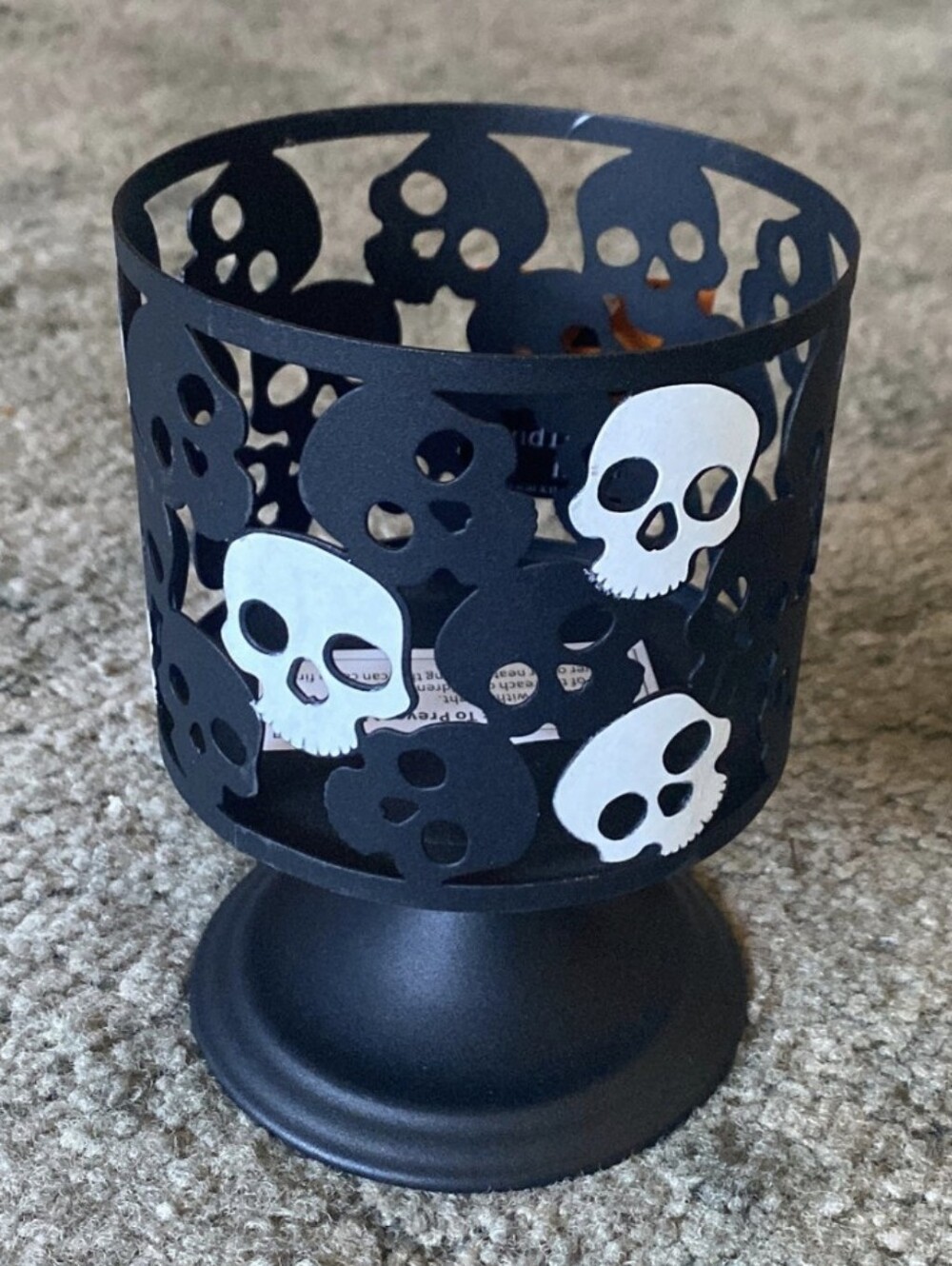 Metal skull cutout candle holder